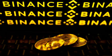 Bitcoin coins with Bitcoin crypto exchange logo in the background