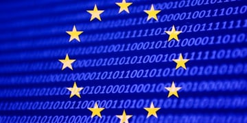 The EU flag placed on a screen full of code.