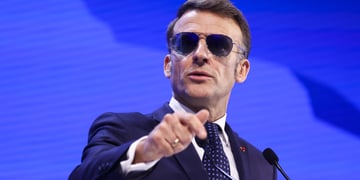 French President Emmanuel Macron wearing sunglasses indoors