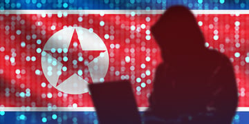 North Korean hacker shadow, flag in the background