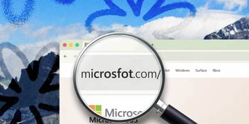 A magnifying glass revealing a URL that's spelled "Microsfot" instead of "Microsoft"