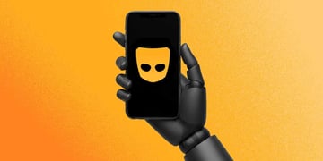 A robot's hand holding a smarphone with Grind's logo on the screen
