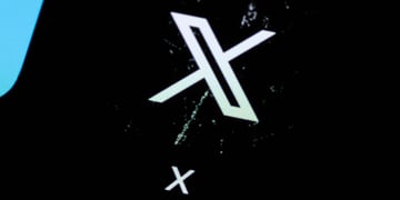 X app logo on phone screen, scratched