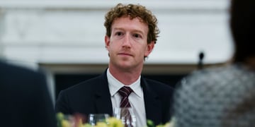 Mark Zuckerberg at dinner table, black tie, pale skin, white shirt, black eyes, curly hair