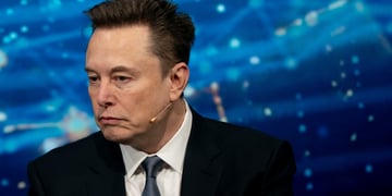 elon musk facing left, blue background, little white web-like lights, black suit 