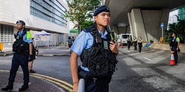 hong kong police officer, black bulletproof west, young asian man, blue short sleeve shirt
