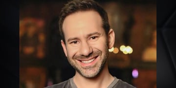 OnlyFans owner Leonid Radvinsky in grey shirt, smilind, black short beard, dark eyes, white teeth