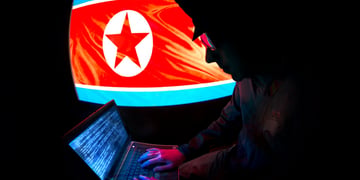 north korean hacker, flag on screen, military hat, open laptop, blue screen, numbers