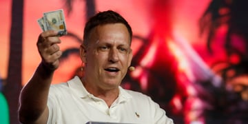 peter thiel, man, brown hair, white polo shirt, holds dollars, red sunset, palm tree