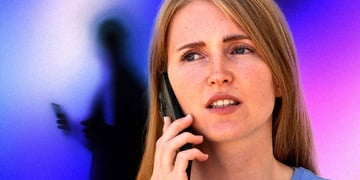 Woman with confused expression on a phone targeted by a scammer