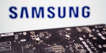 black microchip with metalic details, samsung blue logo in blurry white background