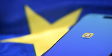 snapchat icon on phone with blue screen, eu flag, yellow star