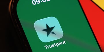 trustpilot baby blue icon with black star, green, orange, and yellow smartphone screen