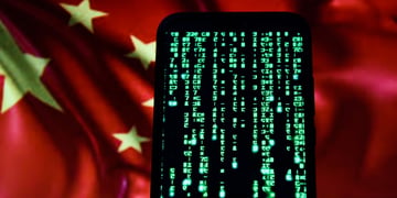 matrix green code on black smartphone screen, red china flag in the background, yellow star