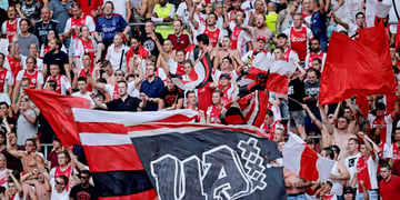 ajax club supporters, red and white flags, red and white shirts in crowd in stadium