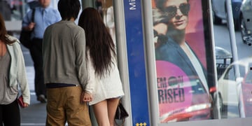 asian couple, long black hair, very short jeans shorts, long white legs, white sweater, busy street