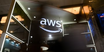 The Amazon Web Services (AWS) logo is visible at the India Mobile Congress 2025