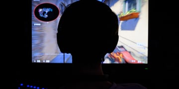 A counterstrike gamer playing in the dark.