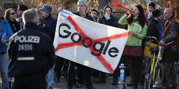 Protesters make noise outside the Umspannwerk building where U.S. tech company Google