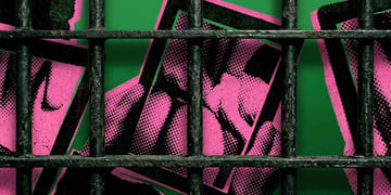 Cell bars and hands holding a tablet with erotic content