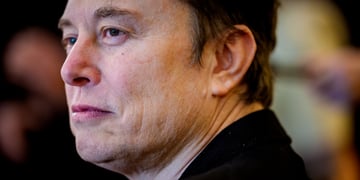 elon musk, profile, black suit, face close up, curly eyebrow, wrinckles on face skin