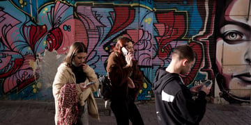 teenagers on phones, blue graffitti, 