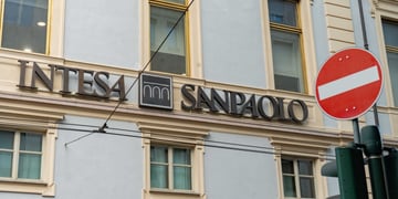 intensa sanpaolo sing over green windows, wall exterior, red stop sign
