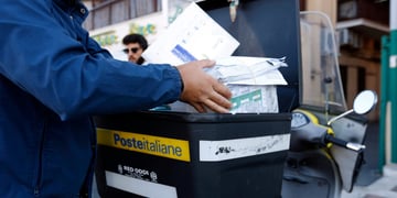 Poste Italiane SpA postman, black box, white envelopes, blue jacket, black hair, male