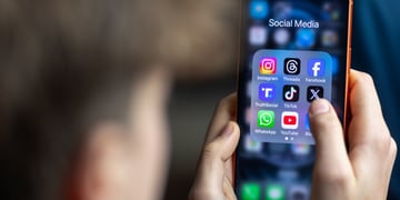 young teen boy, grown hair, iphone black screen with Instagram, Youtube, Facebook ,TikTok apps