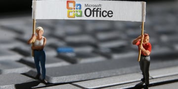female and male mini figurines, grey keyboard, microsoft office banner, white vest, blonde hair