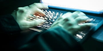 Hands on a keyboard typing.