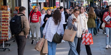 busy london street, many people, brown, red shopping bags, jeans, blue jeans, red t-shirt