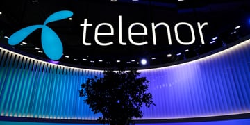telenor white sign in black background, blue stage