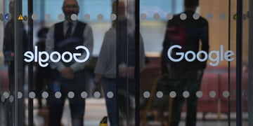 Google office in london, walkout, glass door, Google sign, two shadowy people behind glass