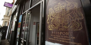 dark red british passport in window