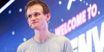 Vitalik Buterin, young pale white man, light brown gingerish hair, grey t-shirt, welcome to sign
