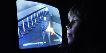 young blonde white boy, blue screen, shooter, yellow laser beam, staircase, old tv screen
