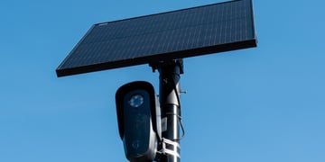black flock camera, clear blue sky, black solar panel