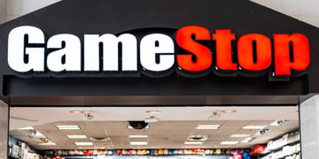 game stop logo above a physical shop with computer games, white and red letters, black back 