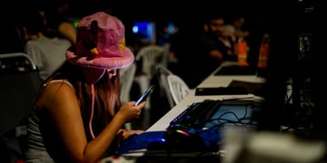 tenage girl, fluffy pink had, smartphone, computers, dark, tanned white skin, dark room