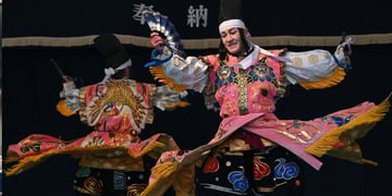 men in traditional japanese kimonos dance on stage, white sleeves, white head tie