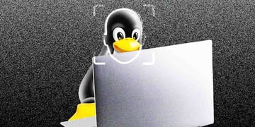 linux penguin, grey laptop, dark grey background