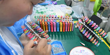 manicure, white chinese woman face, orange, pink, lemon green, yellow plastic nails.