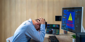 man, office, head in hands, blur computer screen