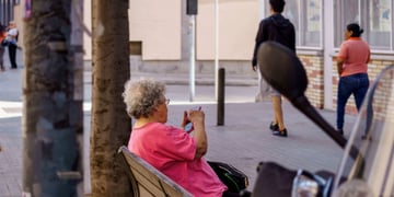 Older woman outside using a smartphone