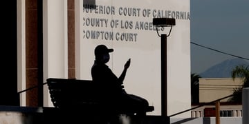 The Superior Court of California County building, man shadow on bench, lighthing poll