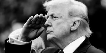 A black and white photo of President Trump saluting.