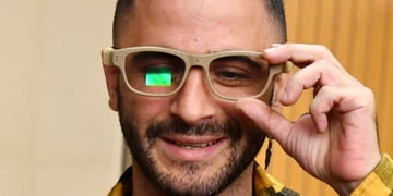white man, mustard-color shirt, short black hair ,black beard and moustache, glasses