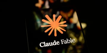 claude fable logo reflected on a black smartphone screen, orange