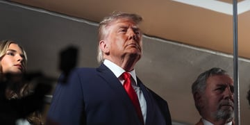 donald trump, black coat, white collar shirt, bright red tie, chin up, ivanka trump head in the left